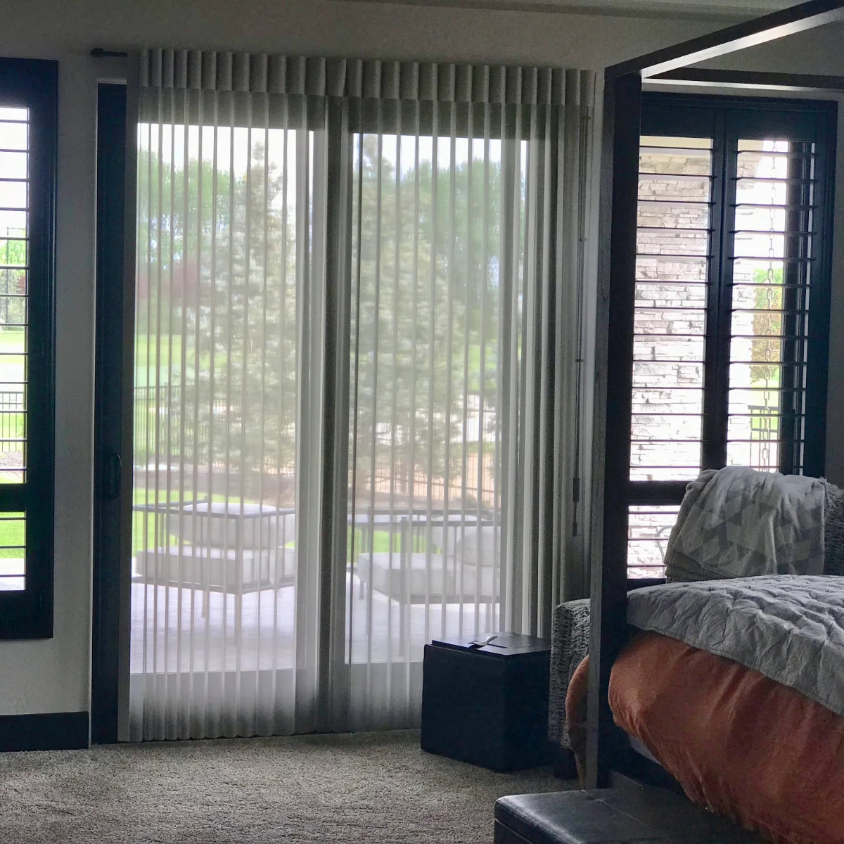 Hunter Douglas Heritance real-wood shutters beside Luminette sheer vertical drapery
